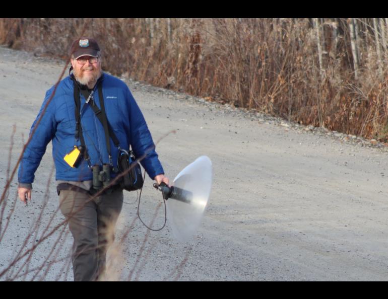 Doug Wacker walks a Fairbanks road last fall while pursuing ravens, the voices of which he is recording. Photo by Kim Wacker.