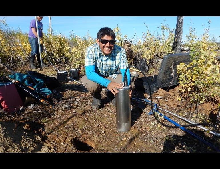 Photo by Carl Tape. University of Alaska Fairbanks doctoral student Kyle Smith installs a T120 posthole seismometer at a site in the Minto Flats of central Alaska in September, 2015.