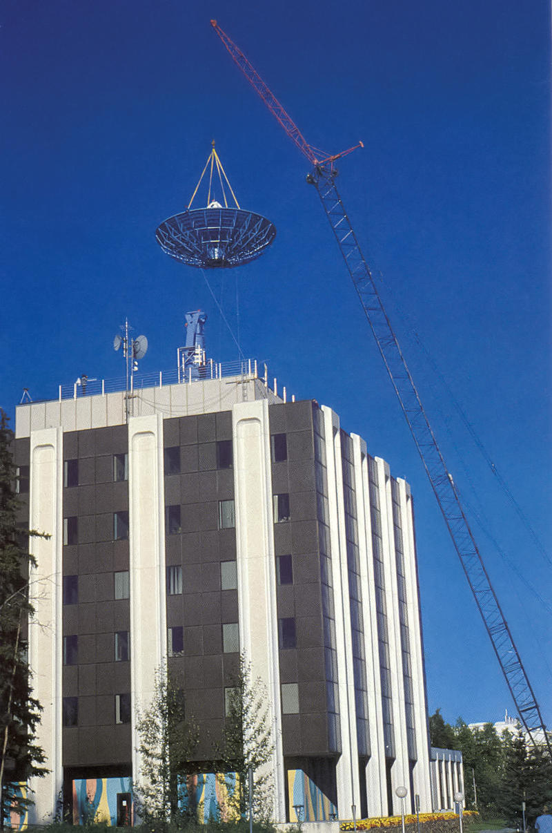 Dish hanging by crane over Elvey building