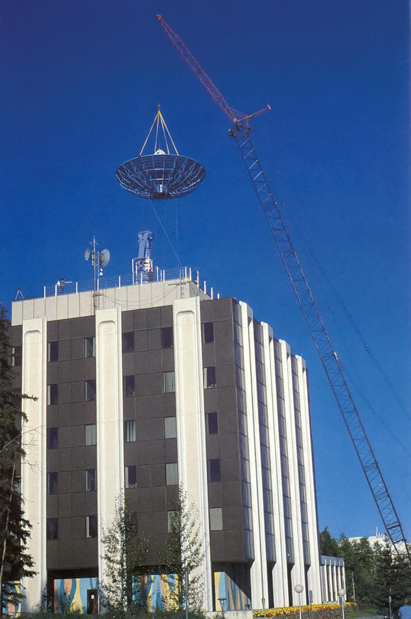 Dish hanging by crane over Elvey building