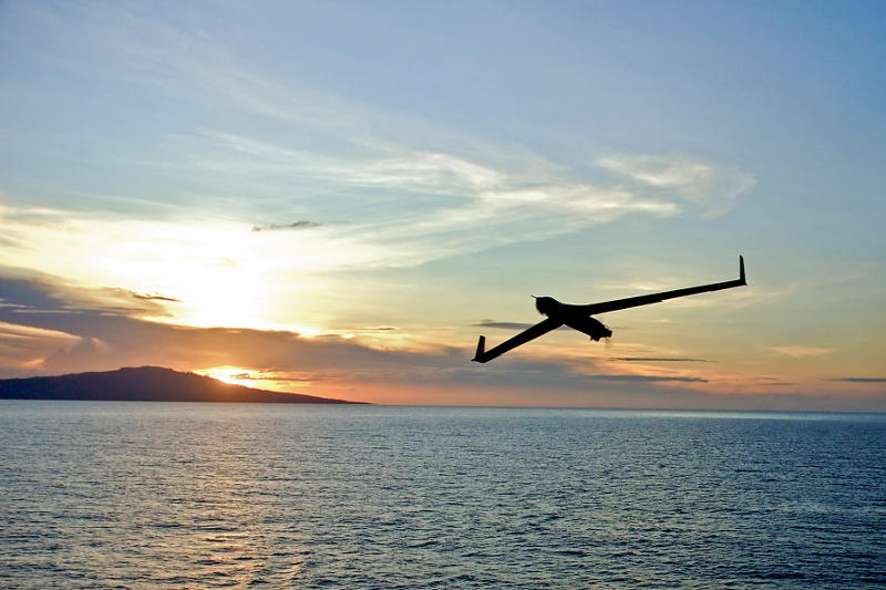 Drone flying over a body of water