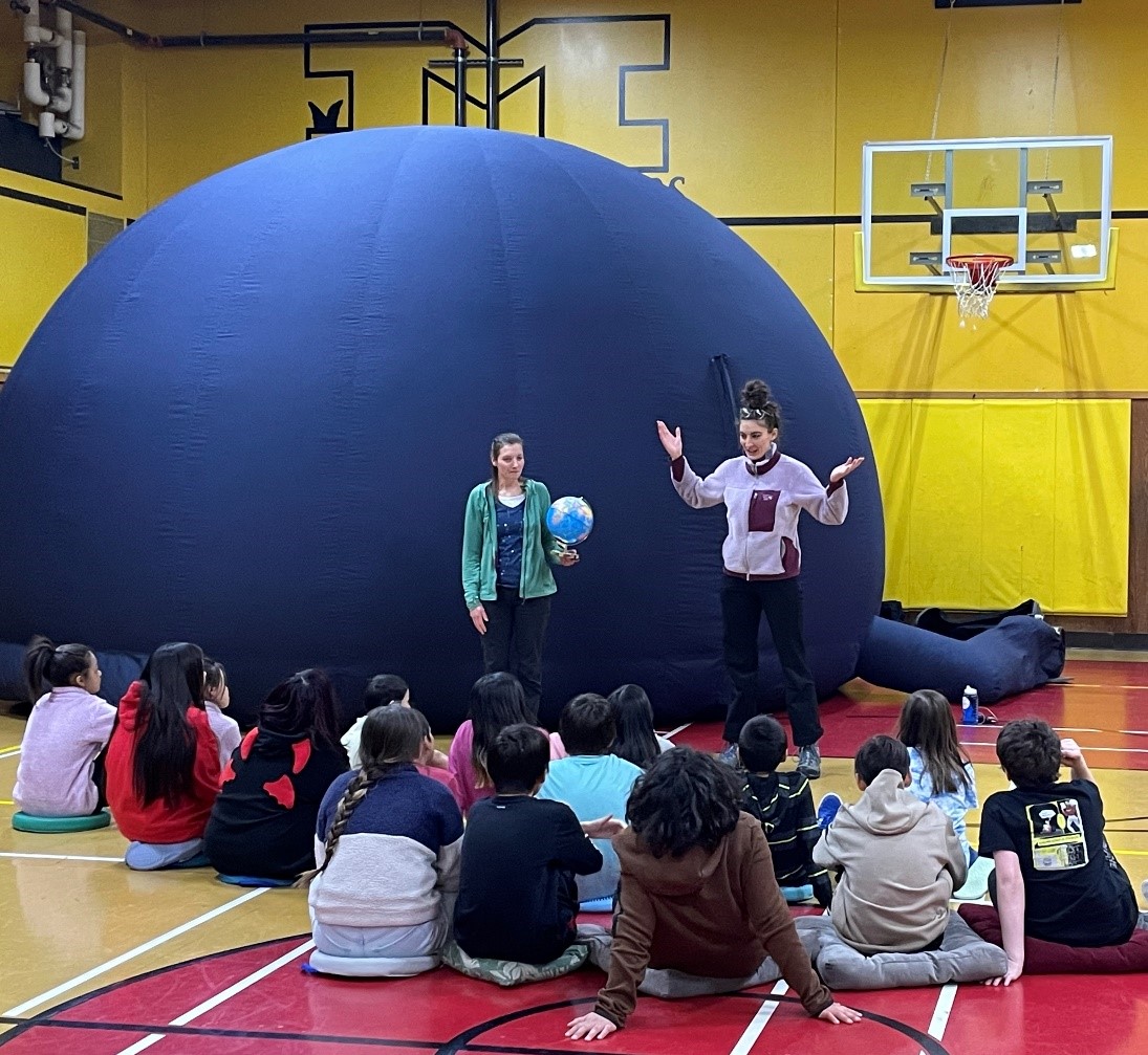 Students engaging in a lesson before entering the UAF Planetarium