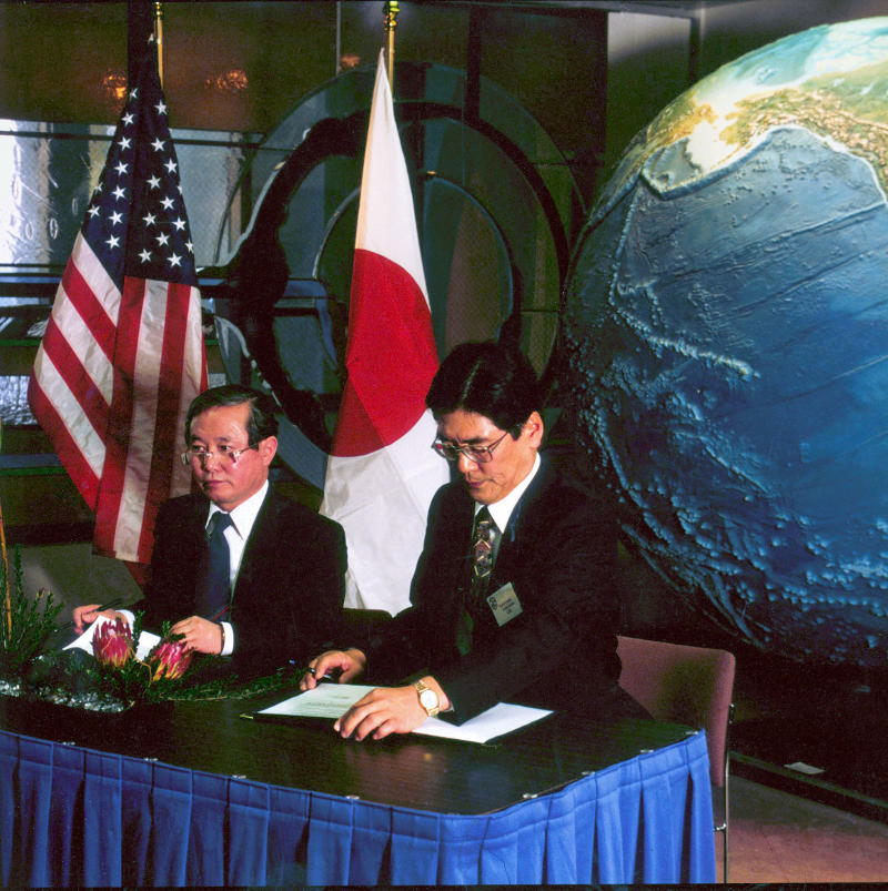 Japanese government leader signing paperwork
