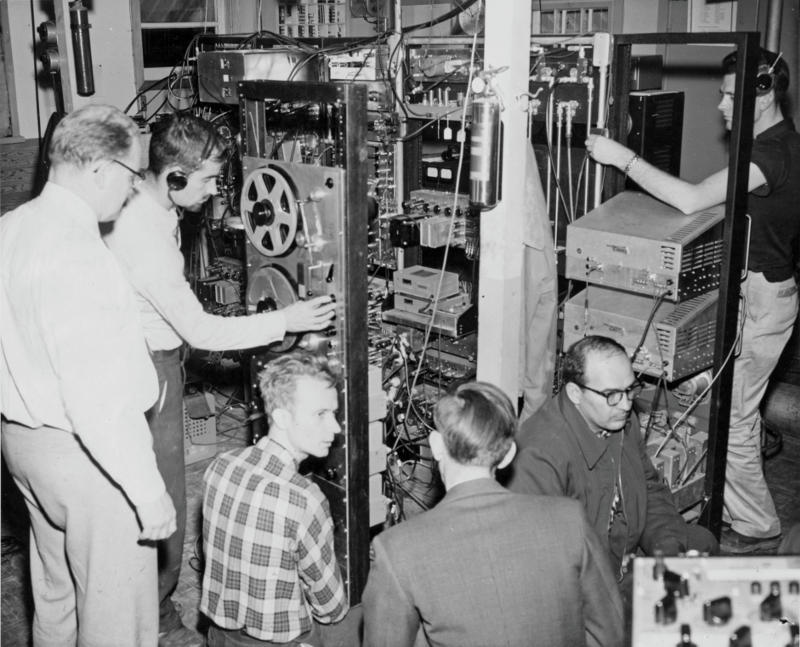 People around machines monitoring sputnik