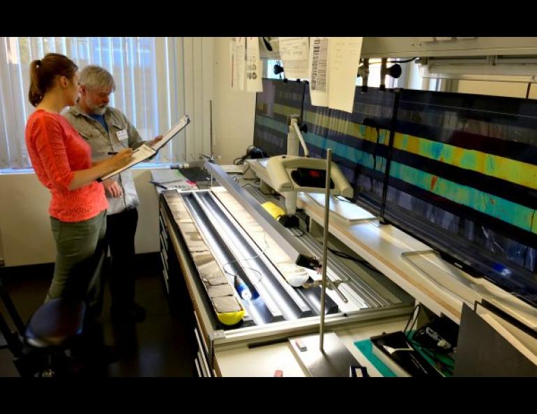 Elise Chenot, of the Université de Bourgogne-Franche Comté, left, and Michael Whalen, of the UAF Geophysical Institute, examine a rock core from the Chicxulub crater in a lab in Bremen, Germany. Photo by Kevin Kurtz.