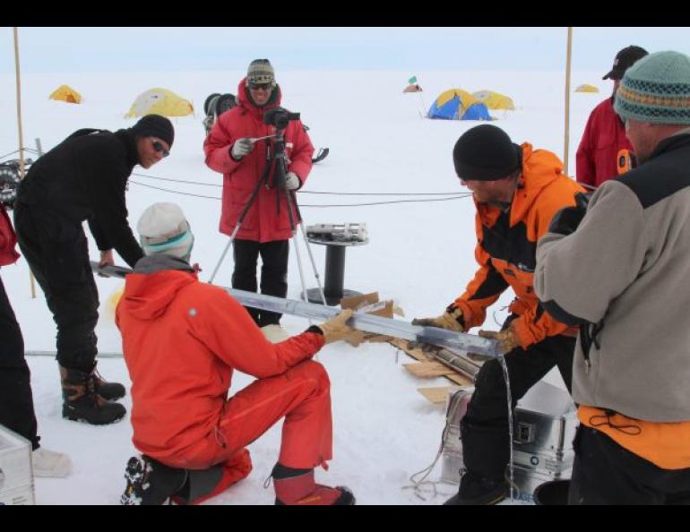 Martin Truffer of UAF’s GI, left, holds a core tube which has brought up a sample of sediment from the sea floor below Pine Island Glacier. Photo by Dale Pomraning.