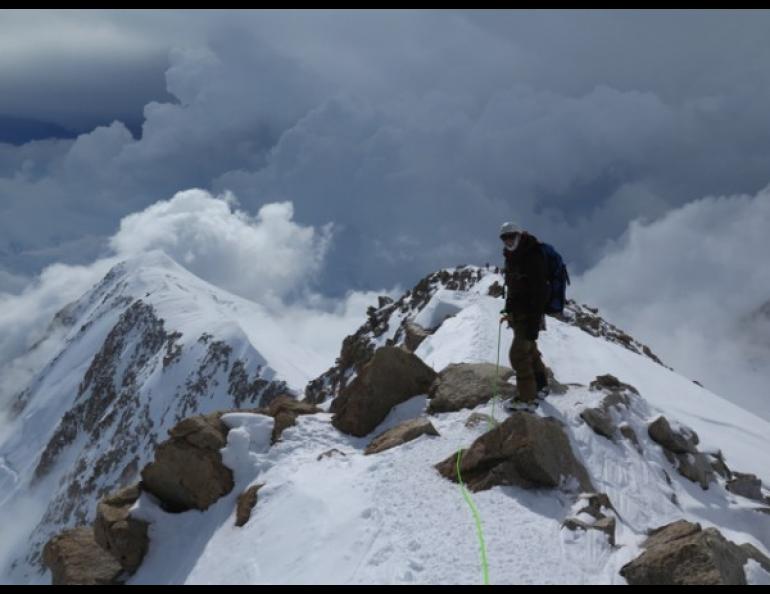 Rhett Foster from CompassData pauses on a ridge leading to the 17,000 foot base camp. Photo by Tom Heinrichs, UAF Geophysical Institute.