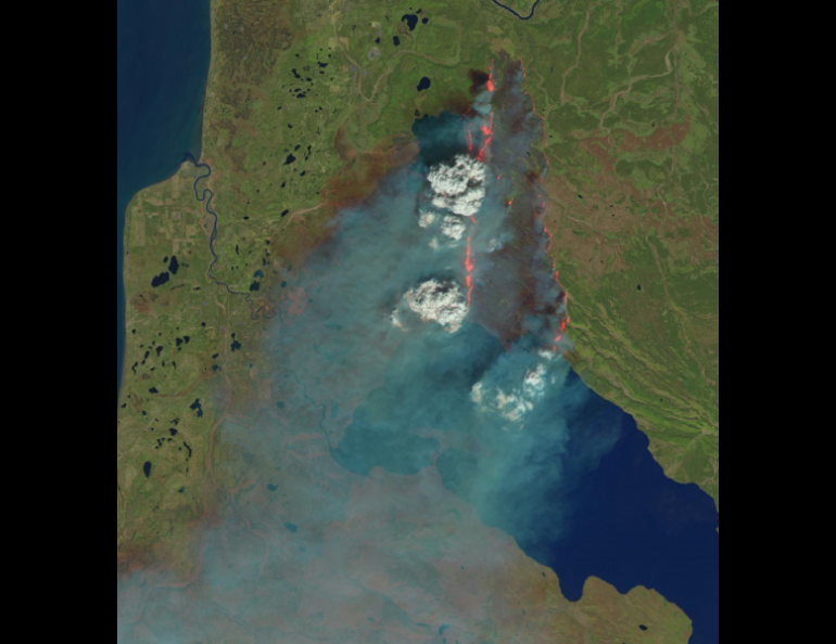 UAF researchers collaborated with a composer to meld original music with remotely sensed imagery of wildfires, such as this example from the 2014 Funny River Fire burning north of Tustamena Lake on the Kenai Peninsula. Photo courtesy of U.S. Geological Survey/NASA/Landsat.
