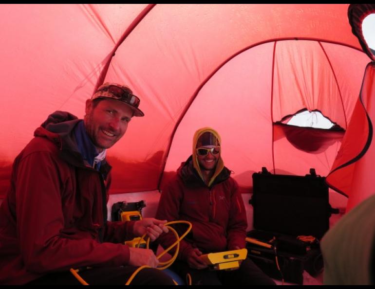 Tom Heinrichs, director of UAF’s Geographic Information Network of Alaska, and Blaine Horner, with CompassData, prepare a ground-penetrating radar in their tent at 14,000 feet on the slopes of Denali in June 2015.