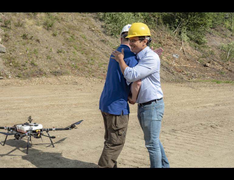 Nick Adkins, director of operations for ACUASI (left) and Troy Mestler, pilot and CEO of Skyfront (right), celebrate the completion of the first true beyond-visual-line-of-sight flight. UAF photo by Sean Tevebaugh