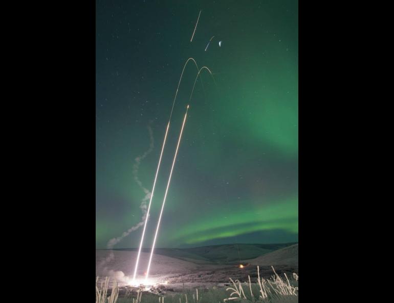 Two rockets rise from Poker Flat Research Range in this composite photograph taken the night of Jan. 25-26, 2015. The aurora is visible across the sky. The 2020 rocket launch window opens Jan. 26. Photo by J. Adkins, NASA.
