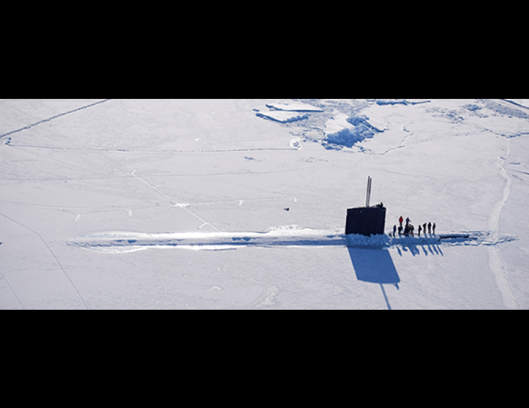 A submarine surfaces through the Arctic Ocean sea ice during a previous naval Ice Exercise. Photo courtesy of Arctic Submarine Lab