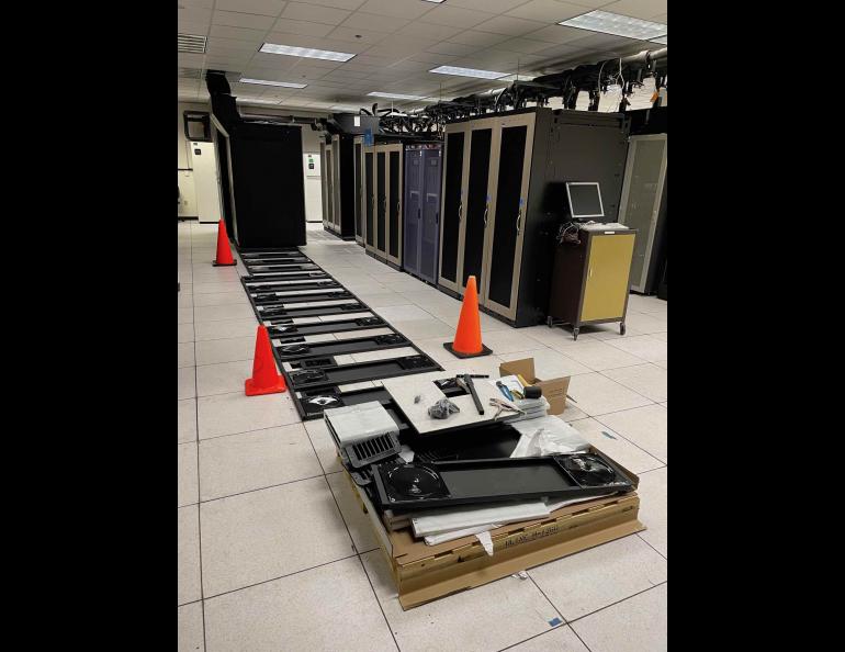Computer rack seismic installation photo: Installation of the Athena computing cluster underway at UAF earlier this year. Photo: Helena Buurman, Alaska Satellite Facility