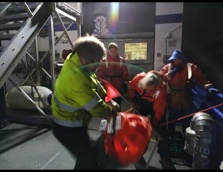 It takes more than an hour for an ocean bottom seismometer to rise from the seafloor to the surface. The device has a piece of buoyant nylon rope attached to it, which the crew grabs by using a grappling hook. Bernard Coakley photo.