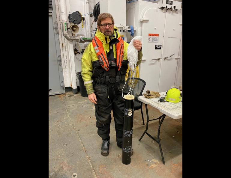 Per Trinhammer, seismic engineer, holds a sonobuoy. These are dropped over the side of the vessel. Saltwater activates a battery, at which point a float with CO2 inflates, bringing the buoy to the surface, and a hydrophone drops and begins to transmit. Bernard Coakley photo.