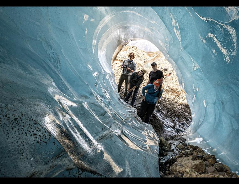 Cameron Markovsky, Tyler Rai, Nina Elder and Hannah Perrine Mode view an ice cave on the Kennicott Glacier during a research expedition this summer. Photo by Julian Dann.