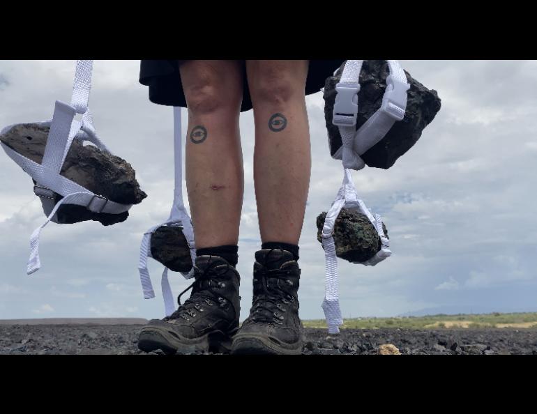 Artist Nina Elder carries rocks — toxic mining slag that was dumped at the U.S./Mexico border as a barrier — as part of an art project that was inspired in part by her time on the Kennicott Glacier in Alaska. Photo courtesy Nina Elder.