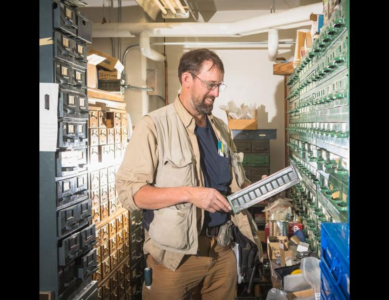 Machinist Dale Pomraning searches for a bolt in the parts aisle of the Geophysical Institute Machine Shop. UAF photo by JR Ancheta.