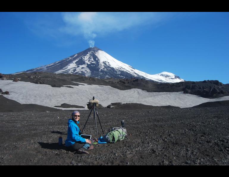 Taryn Lopez uses a ground-based instrument to measure sulfur dioxide emissions at Pavlof Volcano on the Alaska Peninsula in July 2017. Photo by Pavel Izbekov.