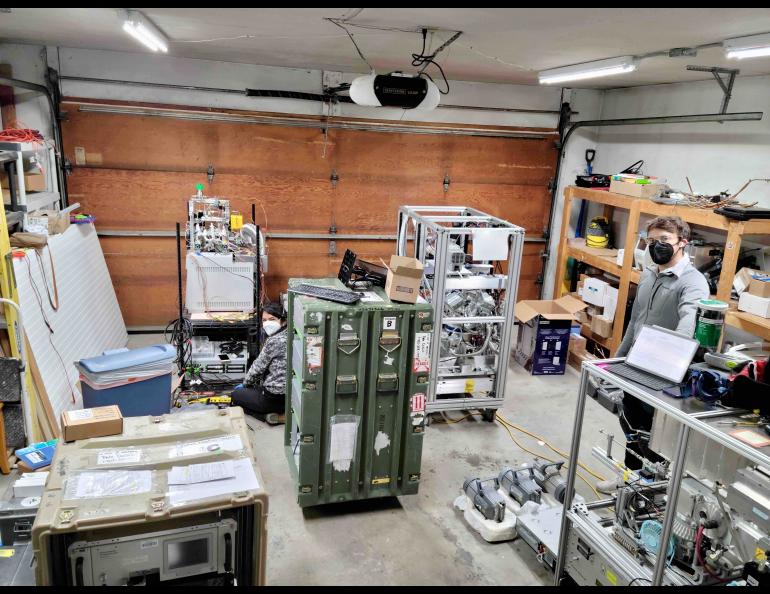 Graduate student Karolina Cysneiros de Carvalho, left, from Washington University at St. Louis and postdoctoral associate Ellis Robinson from John Hopkins University set up instruments to study the indoor air quality at a rented home in Fairbanks. Photo by Jingqiu Mao