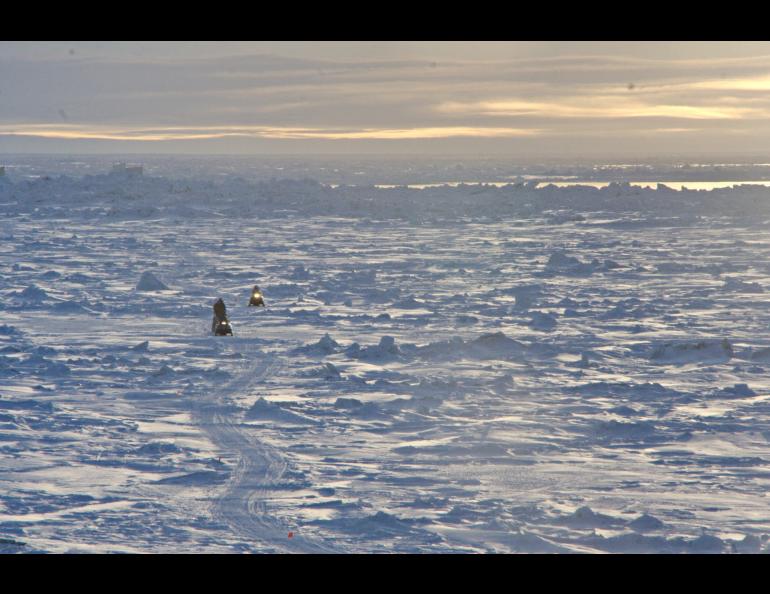 Residents of Utqiagvik return by snowmachine from the lead at the edge of the shore-fast ice. Photo by Andy Mahoney, UAF Geophysical Institute