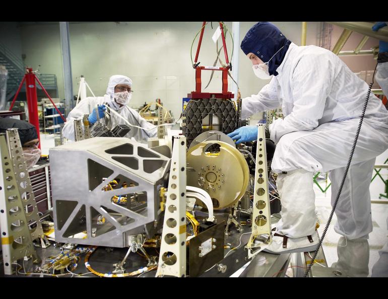 Engineers prepare and install the microshutter array simulator on the NIRSpec Engineering Test Unit at NASA Goddard Space Flight Center. Photo by Chris Gunn/NASA