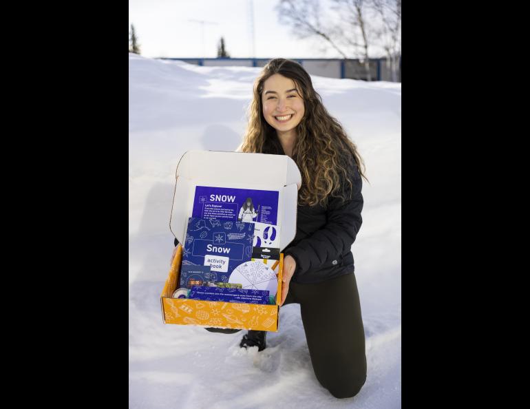  Serina Wesen, education and outreach designer with the Geophysical Institute’s Snow, Ice and Permafrost Group, holds one of the snow kits she helped create. UAF/GI photo by JR Ancheta.