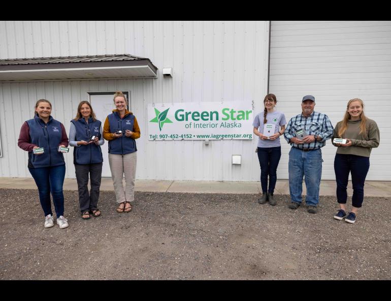 From left, Marine Vanlandeghem Gillespie, Kalee Meurlott and Mariah McNamara, all of the UAF Geophysical Institute, hold recycled equipment along with Cherissa Dukelow, Art Gelvin and Kenzley Defler, of Green Star of Interior Alaska, at the Green Star facility in Fairbanks. Photo by Daniel Walker