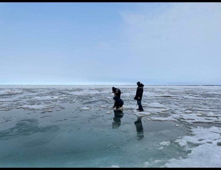 SALVO team members investigating melt ponds on the Chukchi Sea. Photo by Serina Wesen