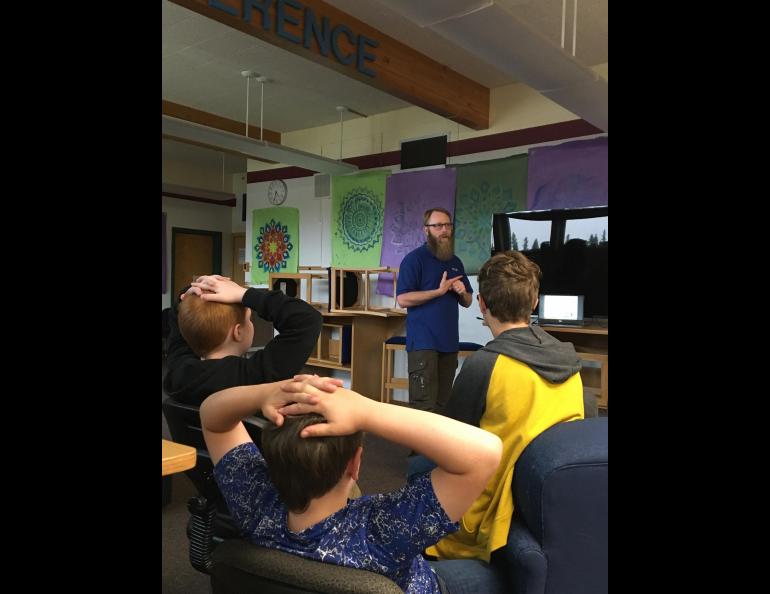Nick Adkins, operations director of the Alaska Center for Unmanned Aircraft Systems Integration, talks with Delta Junction Junior High School students in July about the regulations that govern the flying of drones. Photo by Rod Boyce