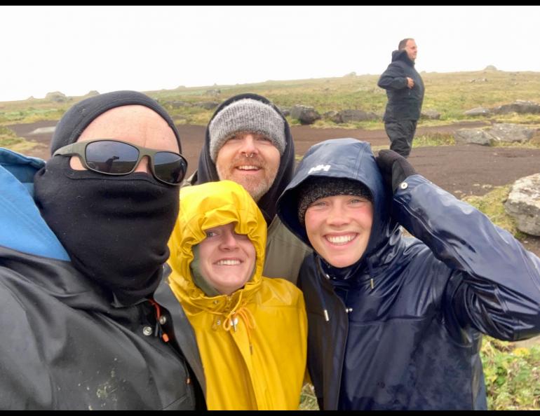 Chris Maio, Lindsey Smith, Matthew Wooller and Harper Baldwin huddle for a group photo as the storm rages. Photo by Chris Maio.