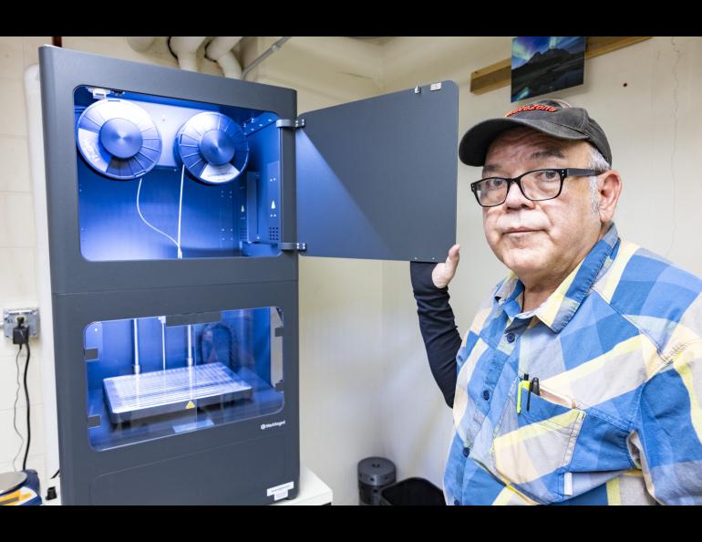 Jesse Atencio, a fabricator in the Geophysical Institute's Machine Shop, shows the new metal 3D printer. Photo by JR Ancheta