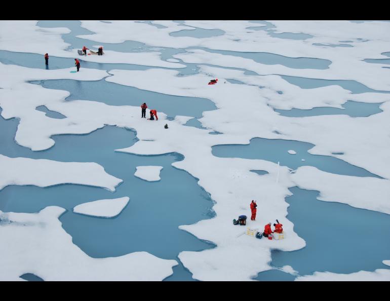 Scientists on the MOSAiC expedition work among Arctic melt ponds in 2020. Photo by Melinda Webster