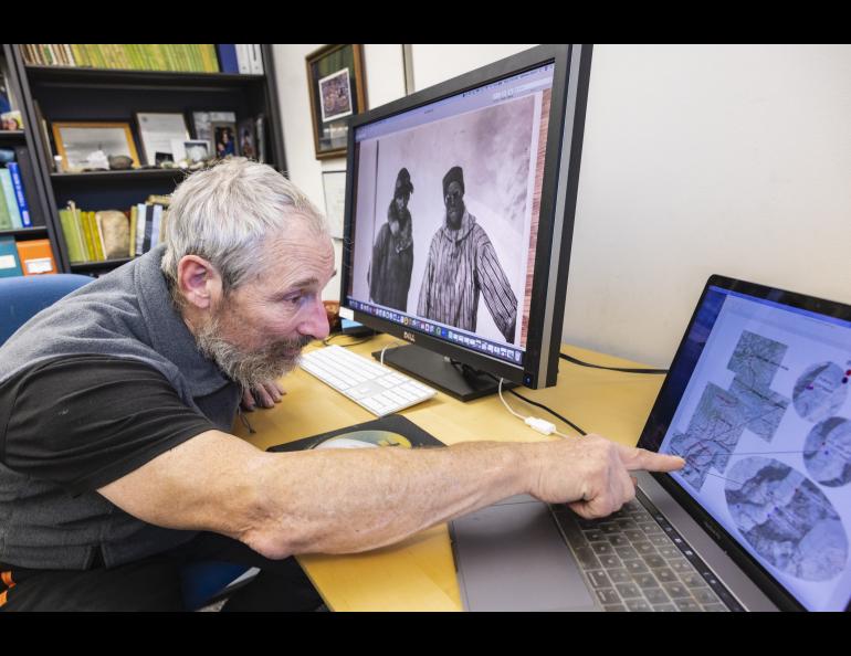 Professor Matthew Sturm points at a map he and climbing partner Philip Marshall created to show the mountain locations of archive photographs and photographs used in a June 1910 New York Times story. UAF/GI photo by JR Ancheta.