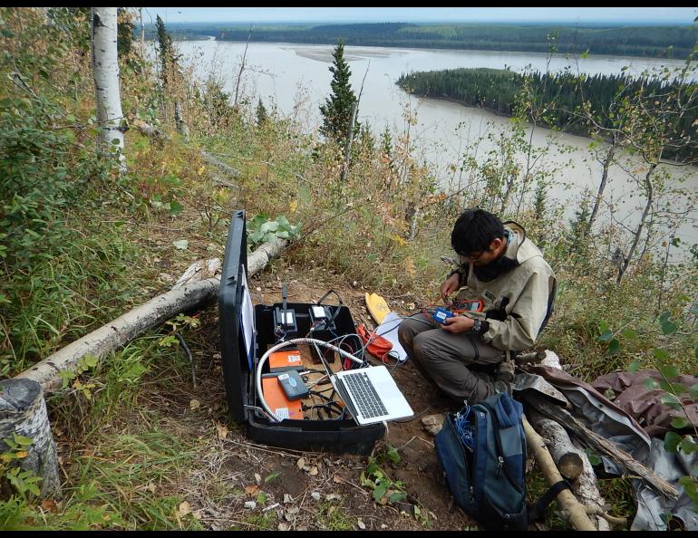 University of Alaska Fairbanks Ph.D. student Kyle Smith services a sensor on Aug. 4, 2018, at a site overlooking the Tanana River on the northwestern side of the Minto Flats. Photo by Carl Tape