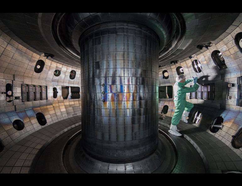 A person works inside the reaction chamber of the DIII-D National Fusion Facility in San Diego. The facility is operated by General Atomics for the U.S. Department of Energy. Photo by General Atomics