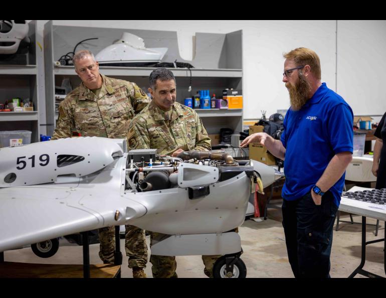 Nick Adkins, deputy director of the Alaska Center for Unmanned Aircraft Systems Integration, explains a Sentry drone to Air Force Lt. Gen. David Nahom, commander of the Alaskan Command, on Aug. 30. UAF/GI Photo by Courtney Holtzclaw.