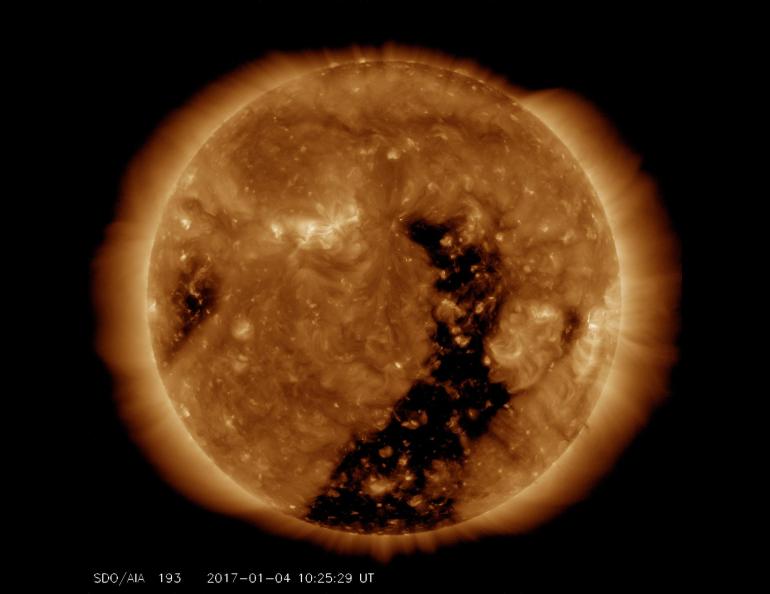 An elongated coronal hole rotated across the face of the sun in January 2017, streaming solar wind toward Earth. Image by Solar Dynamics Observatory, NASA.