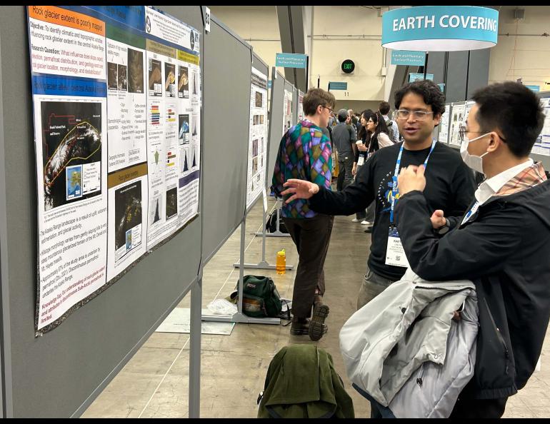 Ph.D. student Kaytan Kelkar of the UAF Geophysical Institute shows his work in the Monday morning poster session at the American Geophysical Union meeting. Photo by Rod Boyce.