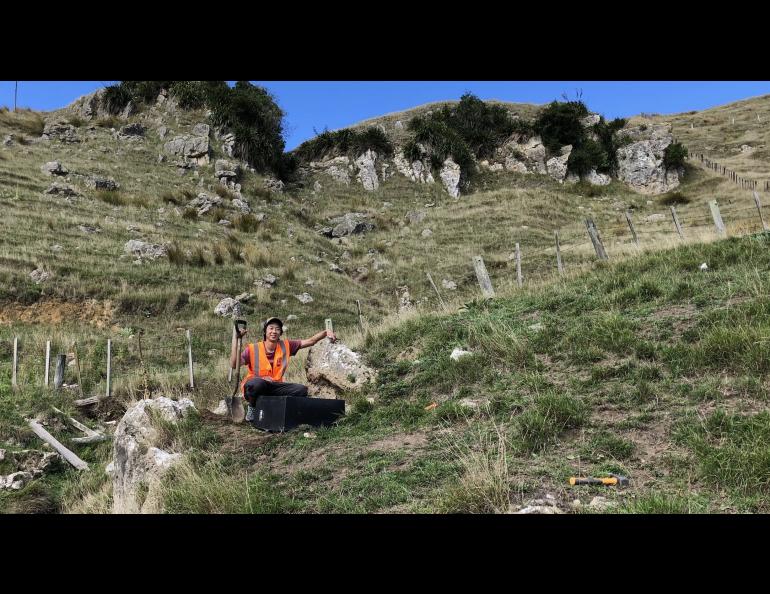 Bryant Chow in front of a seismic station deployed in Hawke's Bay, New Zealand. This station was part of the Broadband East Coast Network, which was deployed to improve data coverage for his imaging research. Photo courtesy Bryant Chow.