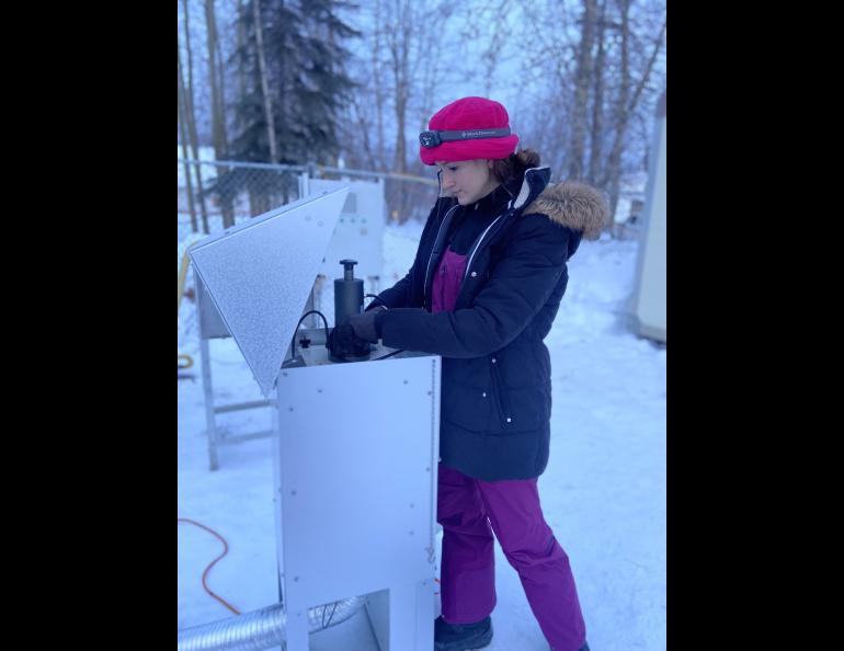 University of Washington graduate student Allison Moon calibrates the flow rate and air volume for the high-volume air sampler to calculate the average ambient sulfate concentrations during the 2022 Fairbanks air quality research campaign. Photo courtesy of Allison Moon.