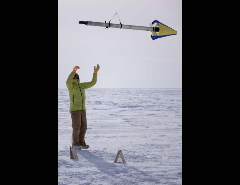 UAF postdoctoral fellow Achille Capelli reaches for the science instrument he designed and built. Photo by Bryan Whitten