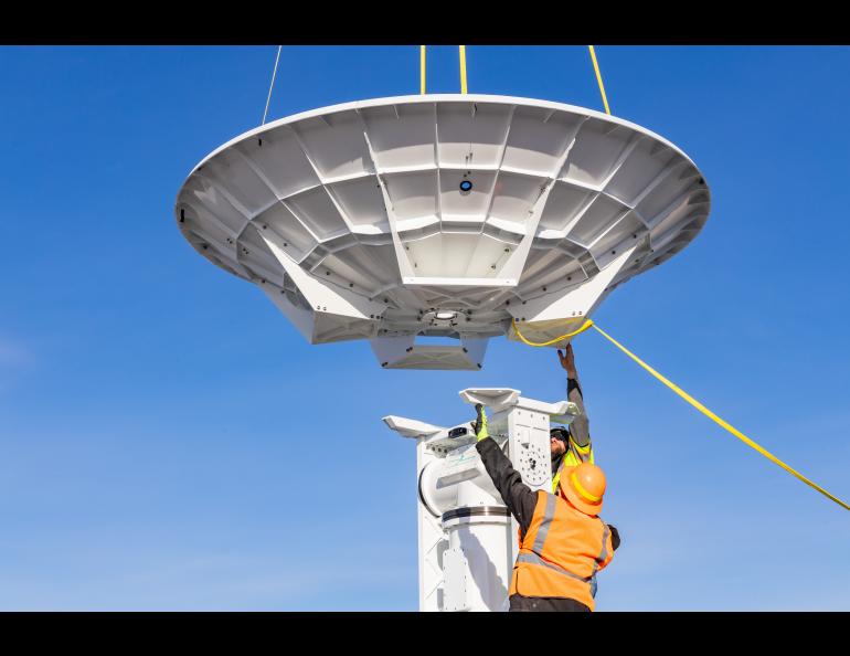 The Geographic Information Network of Alaska (GINA) and UAF Facility Services install a brand new antenna on the roof of the Usibelli Engineering building on Saturday, April 6, 2024. UAF photo by Marina Barbosa Santos