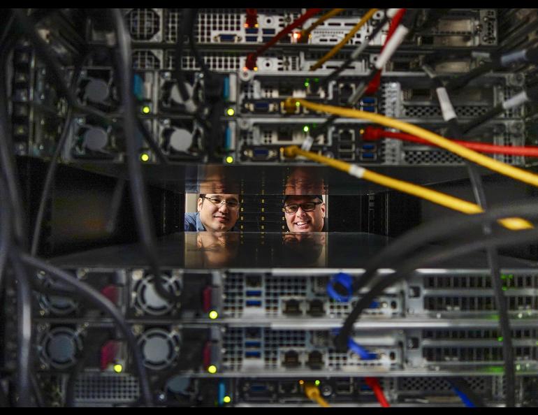 Kevin Galloway, left, Linux systems analyst and Mike Steinhauer, Linux system administrator of the University of Alaska Fairbanks Geophysical Institute Research Computing Systems peer through a rack containing a portion of the high performance computing cluster Chinook. Photo by LJ Evans