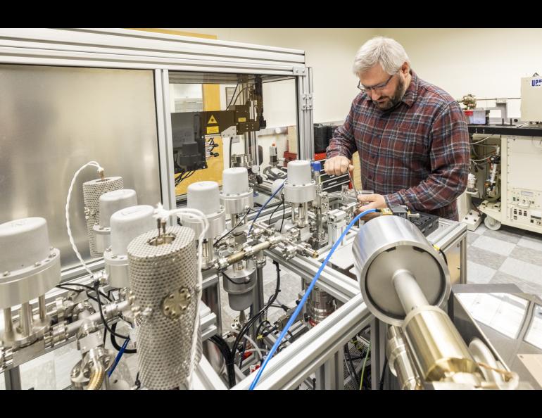 Research assistant professor Florian Hofmann of the UAF Geophysical Institute’s Geochronology Lab works on the lab’s argon mass spectrometer. Photo by JR Ancheta