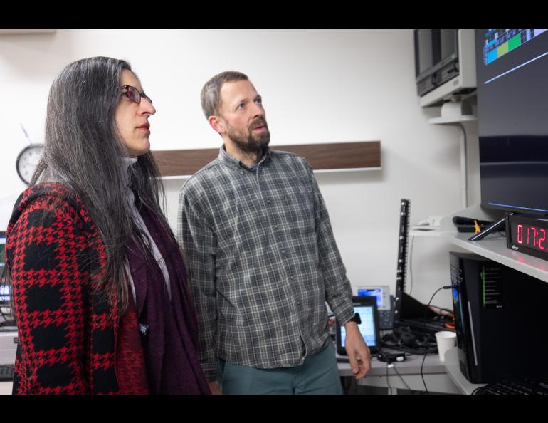 PokerJanuaryPIs: Marilia Samara, left, and Robert Michell are the NASA principal investigators on separate aurora missions launching at Poker Flat Research Range. They are pictured looking at a data display in Poker Flat’s Science Operations Center on Jan. 17, 2025. Photo by Bryan Whitten