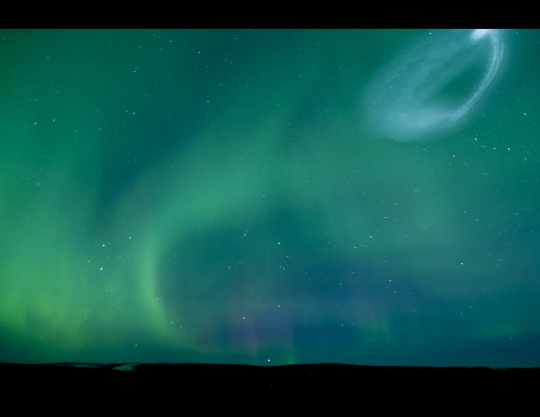 Tracers can be seen overhead at Poker Flat Research Range following the launch of the first rocket of the AWESOME sounding rocket mission on March 25, 2025. Vapor tracers from this and a second rocket launched shortly after the first were visible across a wide area of Alaska. Photo by Bryan Whitten