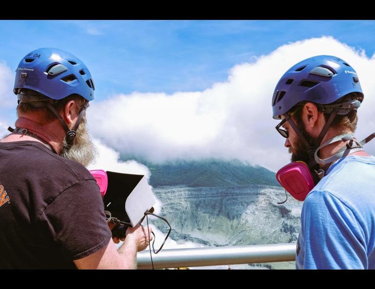 ACUASI pilots Jason Williams, left, and Matthew Westhoff view the flight of a drone into the Poás volcano crater. Photo by Martina Picciallo 