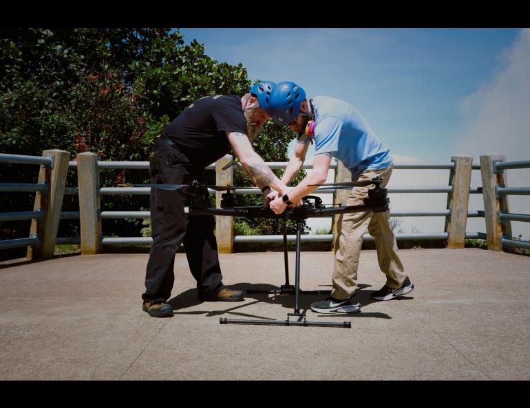 ACUASI pilots Jason Williams, left, and Matthew Westhoff work with the Alta X drone at the Poás volcano crater overlook. Photo by Martina Picciallo 