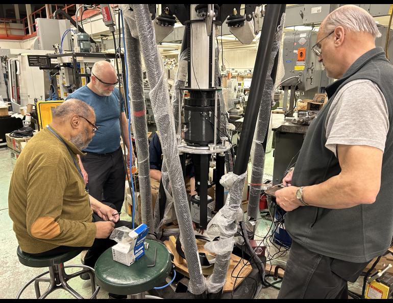 Mark Conde, at rear, oversees work on one of the scanning Doppler imagers at the UAF Geophysical Institute machine shop in mid-2024. Shop personnel Greg Shipman, left, and Lon Sonsalla work on the instrument. UAF/GI photo by Rod Boyce